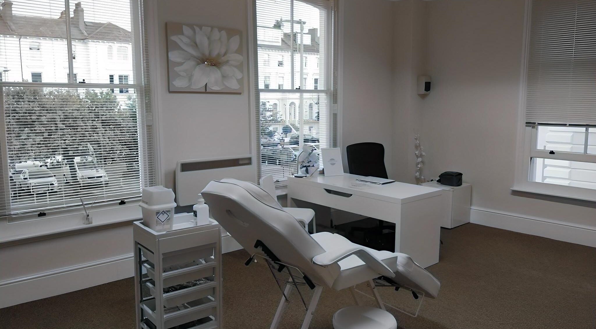 Sleek treatment room at Jnc Aesthetics in Eastbourne, England, GB, showcasing a comfortable chair and serene decor.