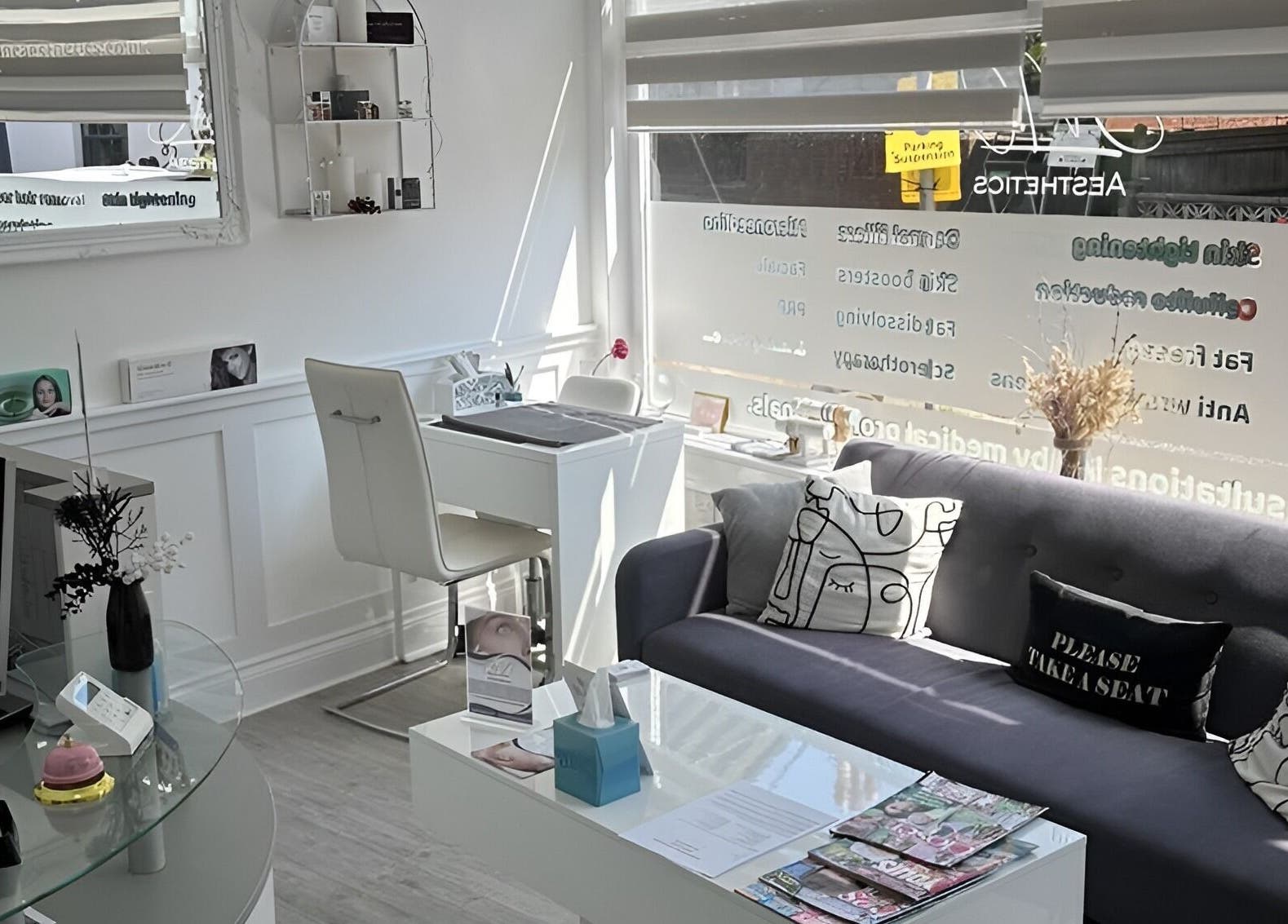 Modern reception area at Jnc Aesthetics in Eastbourne, England, GB with stylish seating and decor.