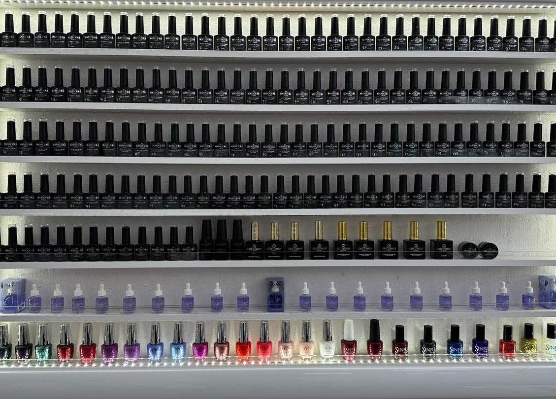 Nail polish collection at Jnc Aesthetics, Eastbourne, England, GB, showcasing a rainbow of vibrant shades.
