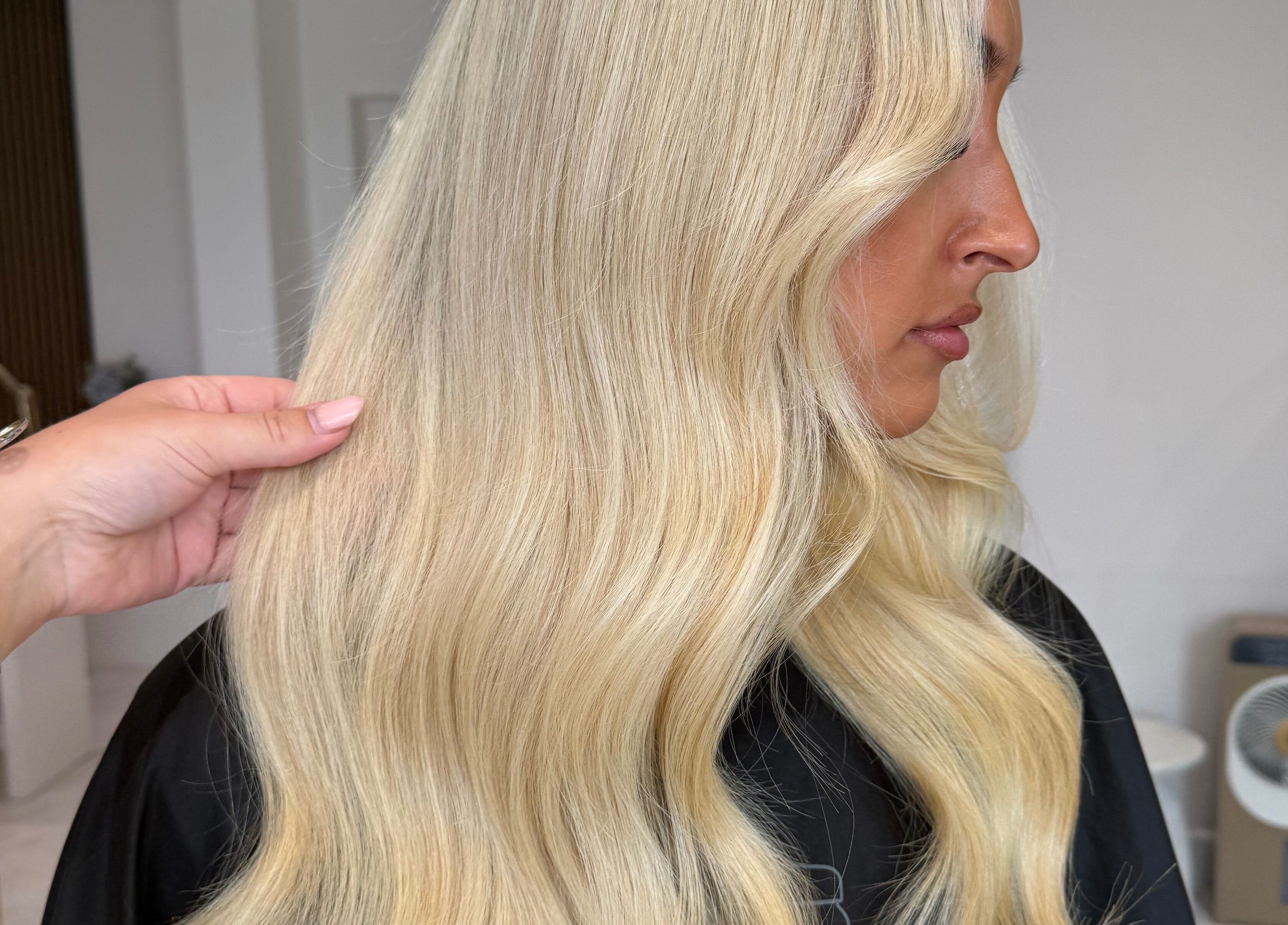 Stylish blonde hair waves at Carrie Fern Price Hair in Chesterfield, England, GB.
