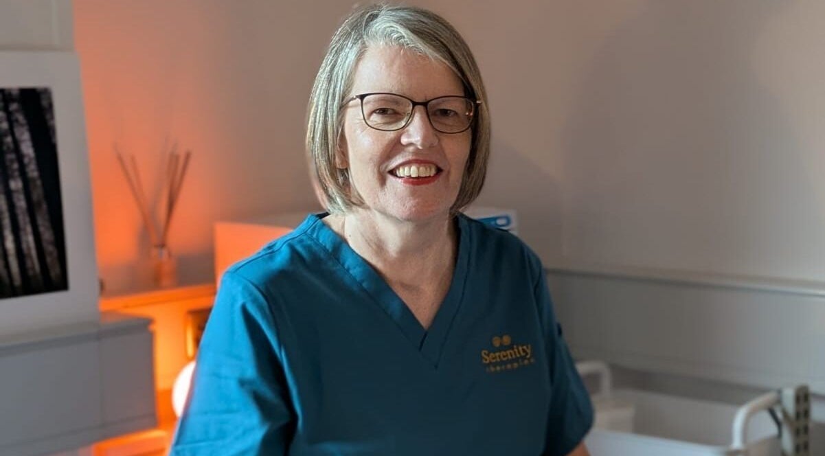 Professional therapist at Serenity Therapies, Killyhevlin, Northern Ireland, GB, smiling warmly.