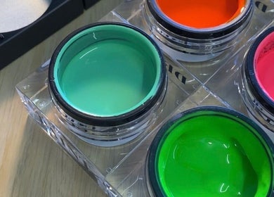 Colorful nail polish jars at Preen, Edinburgh, Scotland, GB offering vibrant beauty services.