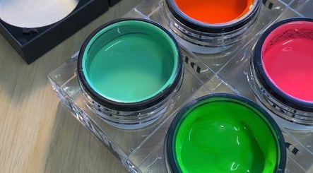Colorful nail polish jars at Preen, Edinburgh, Scotland, GB offering vibrant beauty services.