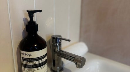 Aesop soap beside a sleek faucet at Preen, Edinburgh, Scotland, GB, emitting luxury and cleanliness.