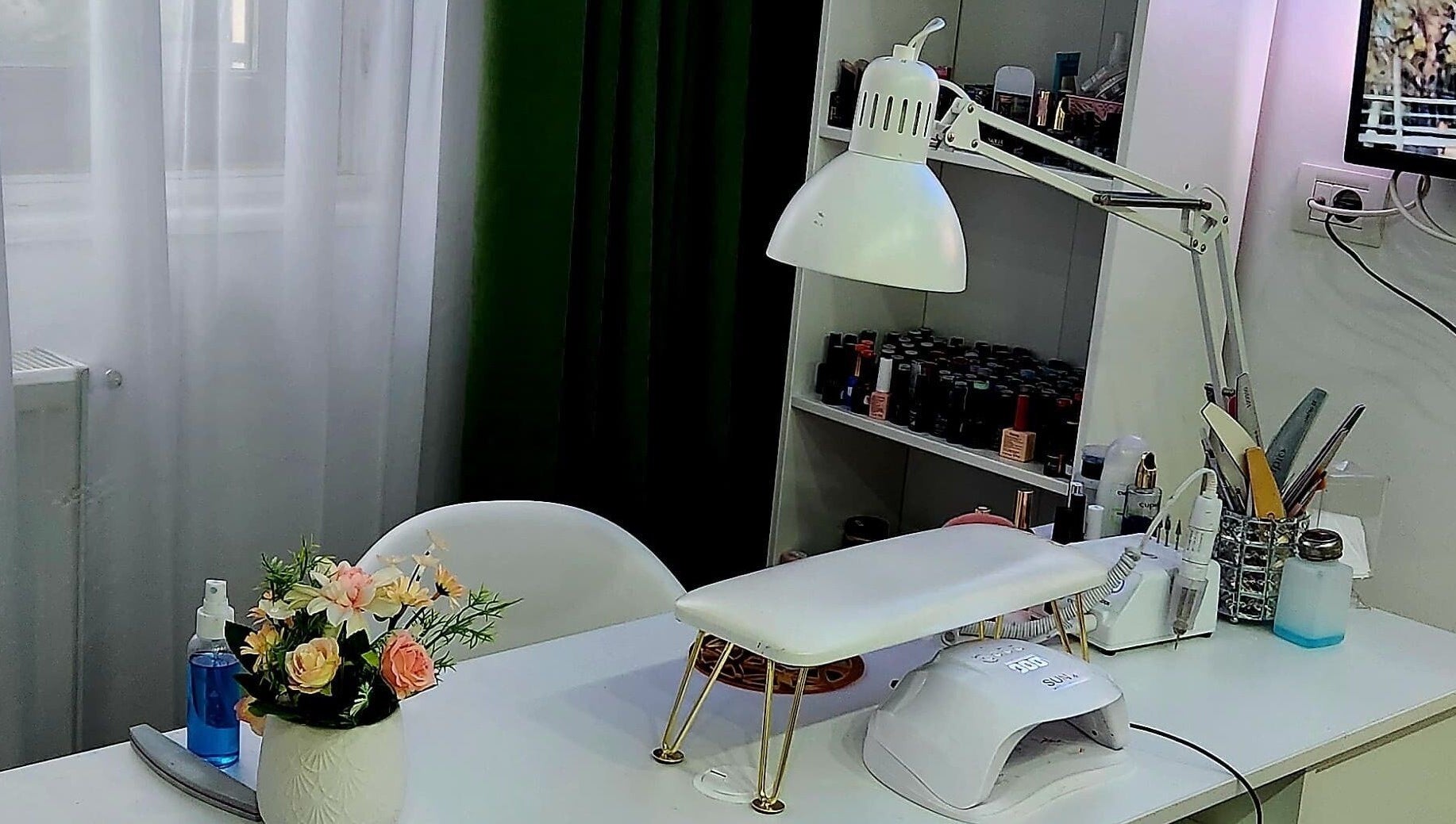 Colț manicure elegant la Nuvia Massage&Nails, București, RO, cu unelte și lămpi moderne.