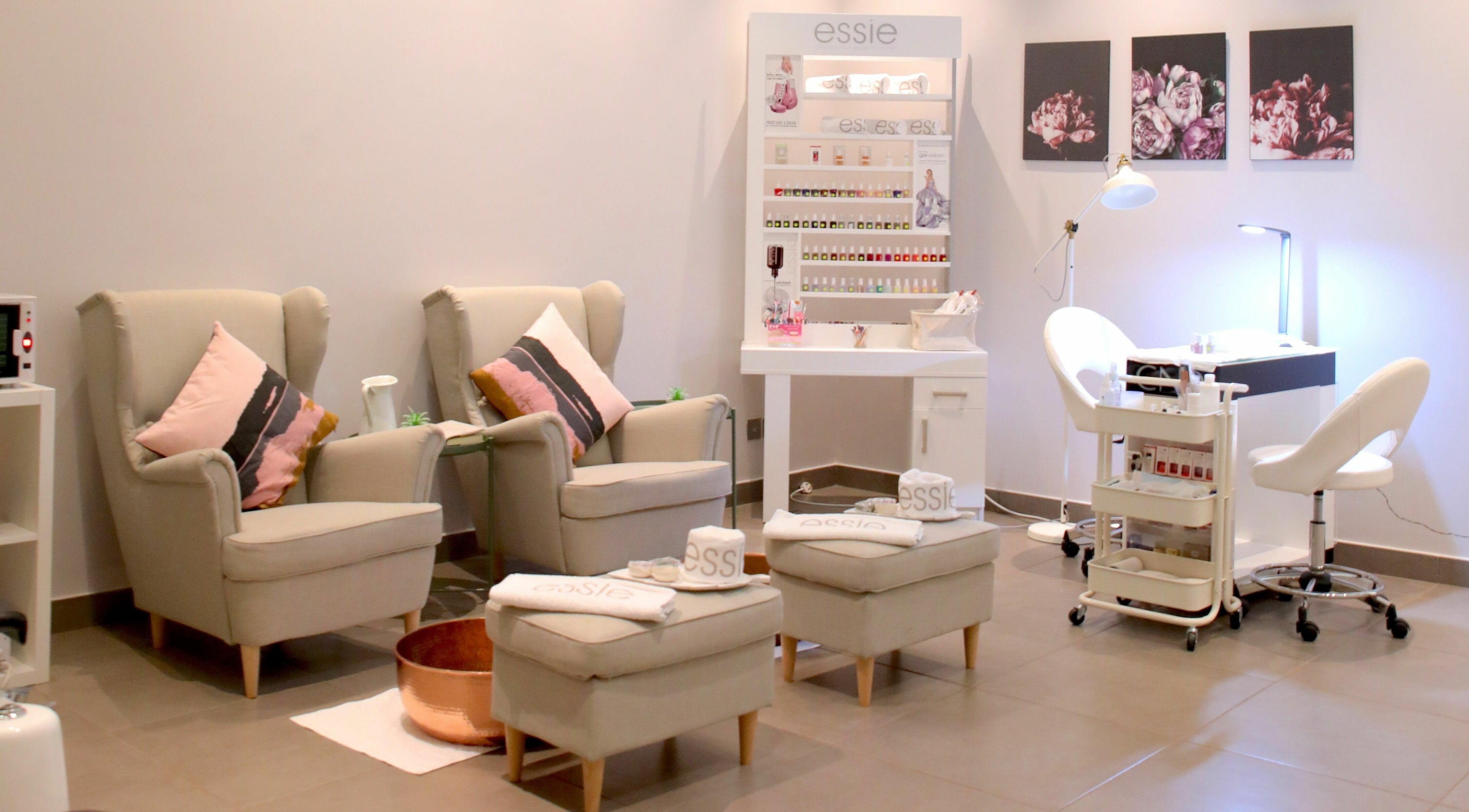 Cozy nail care area at Serenity Beauty Salon in Jeddah, Makkah Province, SA with plush chairs and nail polish display.