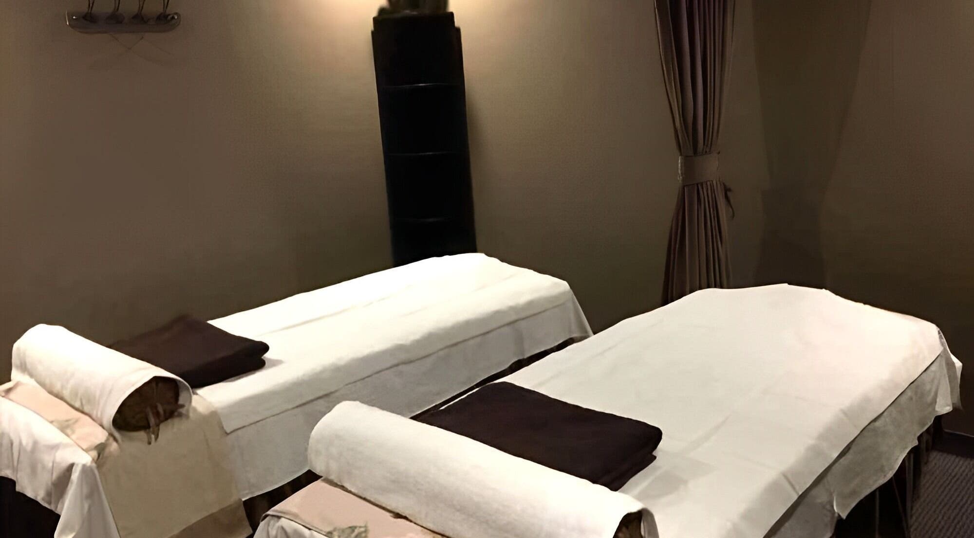 Calming massage room at Sakura Spa, Roxbury Township, New Jersey, US with twin beds for ultimate relaxation.
