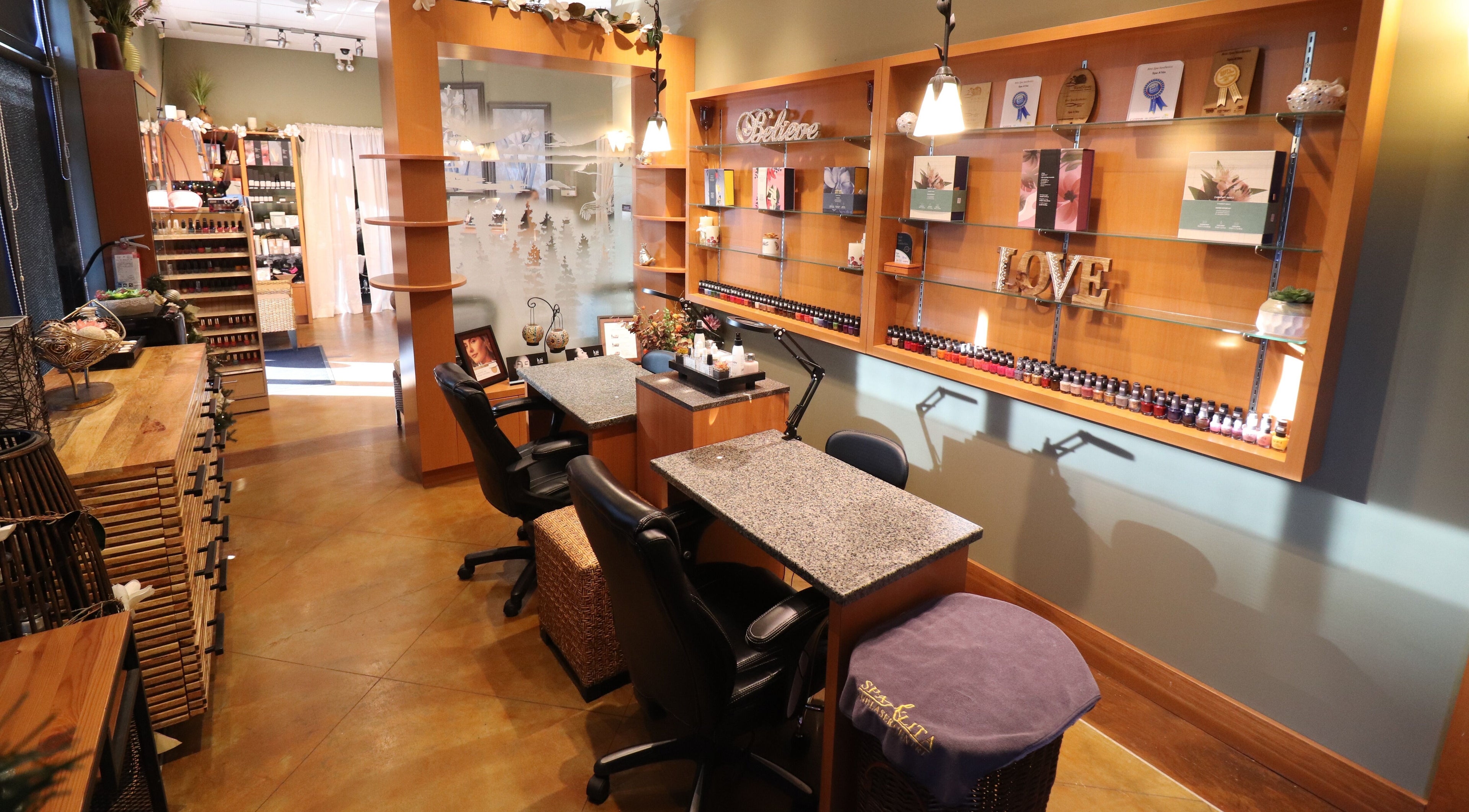 Cozy manicure stations at Spa A'lita, Victoria, British Columbia, CA, with wooden decor and gentle lighting.