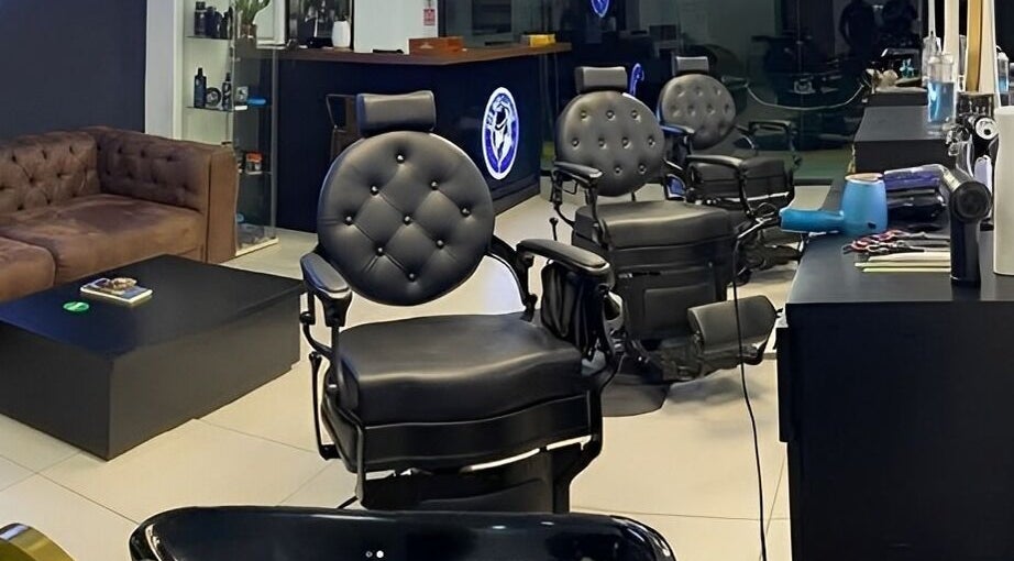 Interior elegante de Utb Men’s Salon en Santiago De Los Caballeros, Santiago, DO con sillones de peluquería de lujo.