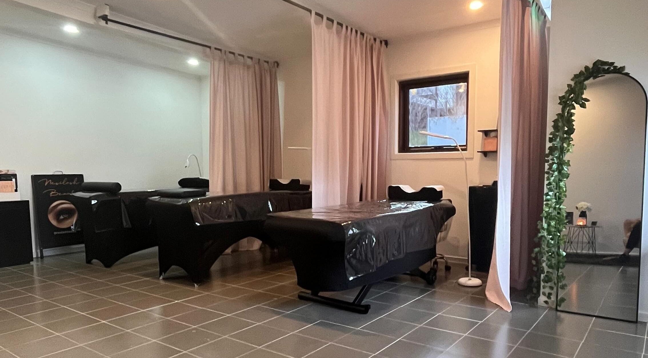 Cozy spa beds with soft lighting at Nesilash Beauty, Melbourne, Victoria, AU, offering a relaxing ambiance.