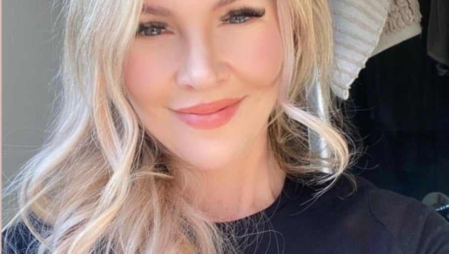Smiling woman showcasing beauty services at Indulge Body and Beauty, Kyabram, Victoria, AU.