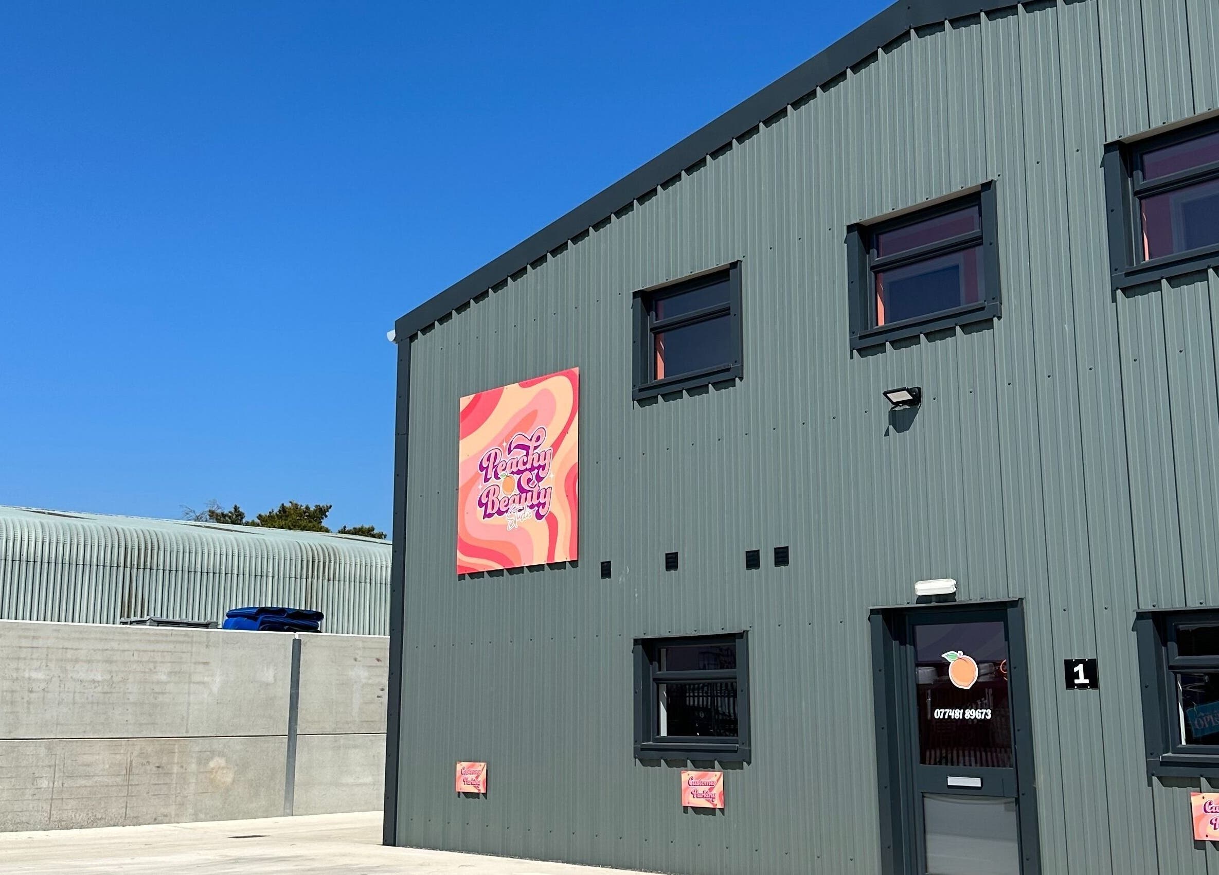 Exterior of Beauty with Ellie, Somerton, England, with vibrant signage on a sunny day.