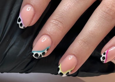 Stylish nail art at Beauty by Em in Clowne, England, GB, featuring colorful animal print tips.