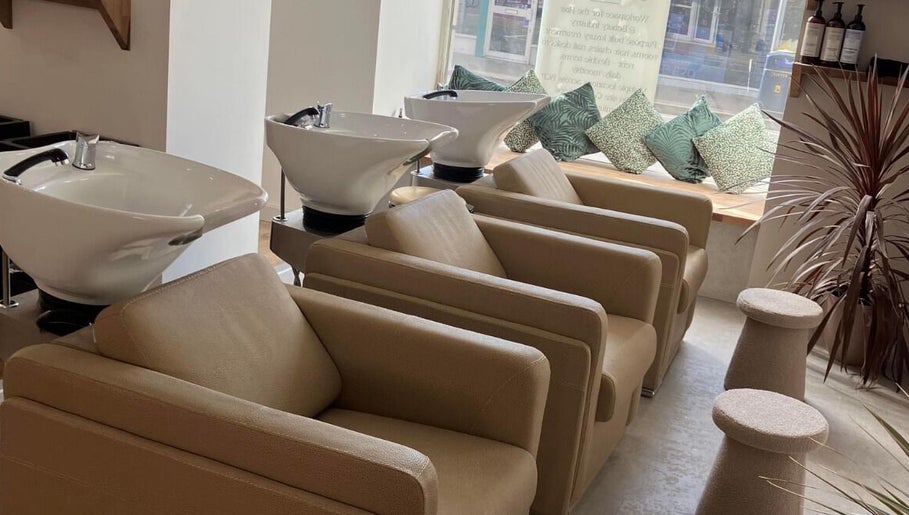 Wash stations at Alice Olivia Hair Designer in Portsmouth, England, GB, featuring modern chairs and decor.