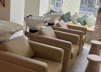 Wash stations at Alice Olivia Hair Designer in Portsmouth, England, GB, featuring modern chairs and decor.