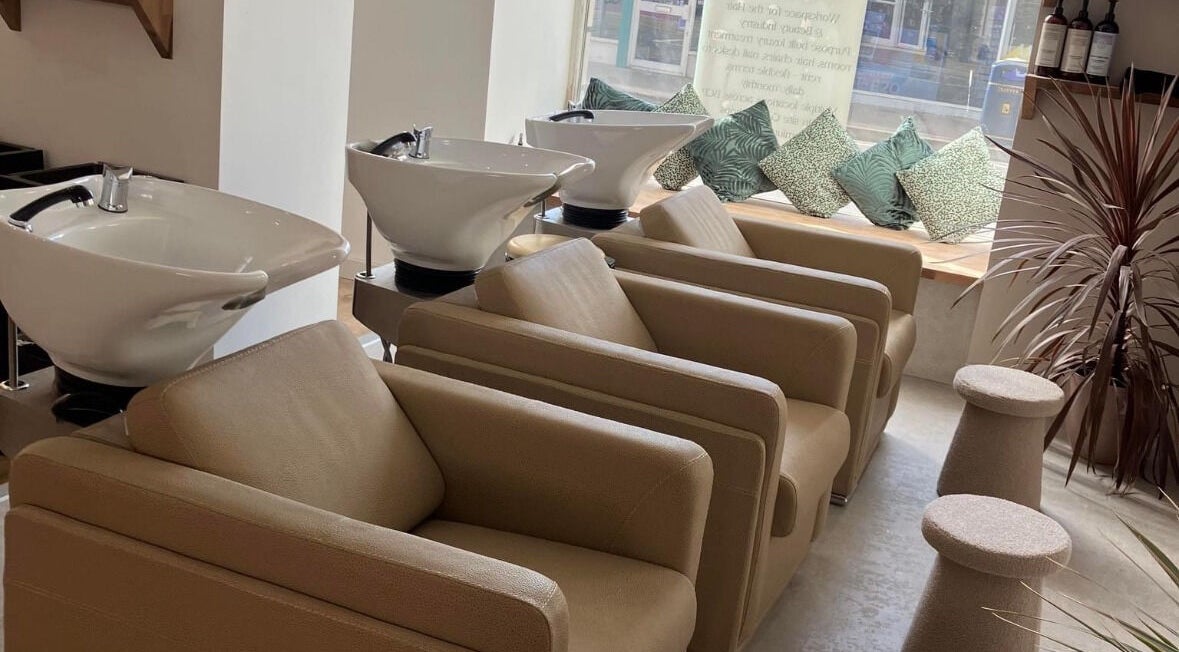 Wash stations at Alice Olivia Hair Designer in Portsmouth, England, GB, featuring modern chairs and decor.