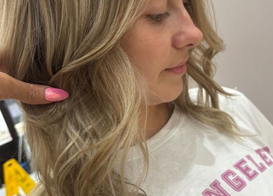 Blonde hair styled at Alice Olivia Hair Designer in Portsmouth, England, GB. Sleek finish with soft waves.