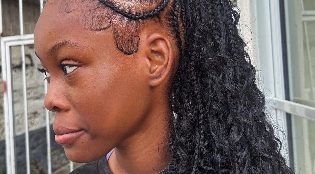 Intricate braided hairstyle at Di’s Hair Den in Bridgetown, BB, showcasing expert styling techniques.