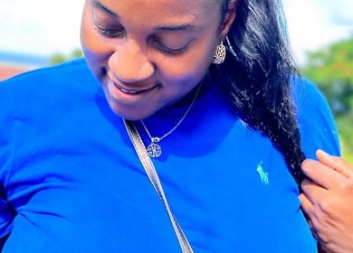 Woman enjoying bright day, showcasing hairstyle at Di’s Hair Den in Bridgetown, BB.