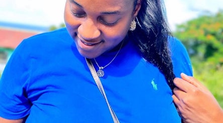 Woman enjoying bright day, showcasing hairstyle at Di’s Hair Den in Bridgetown, BB.