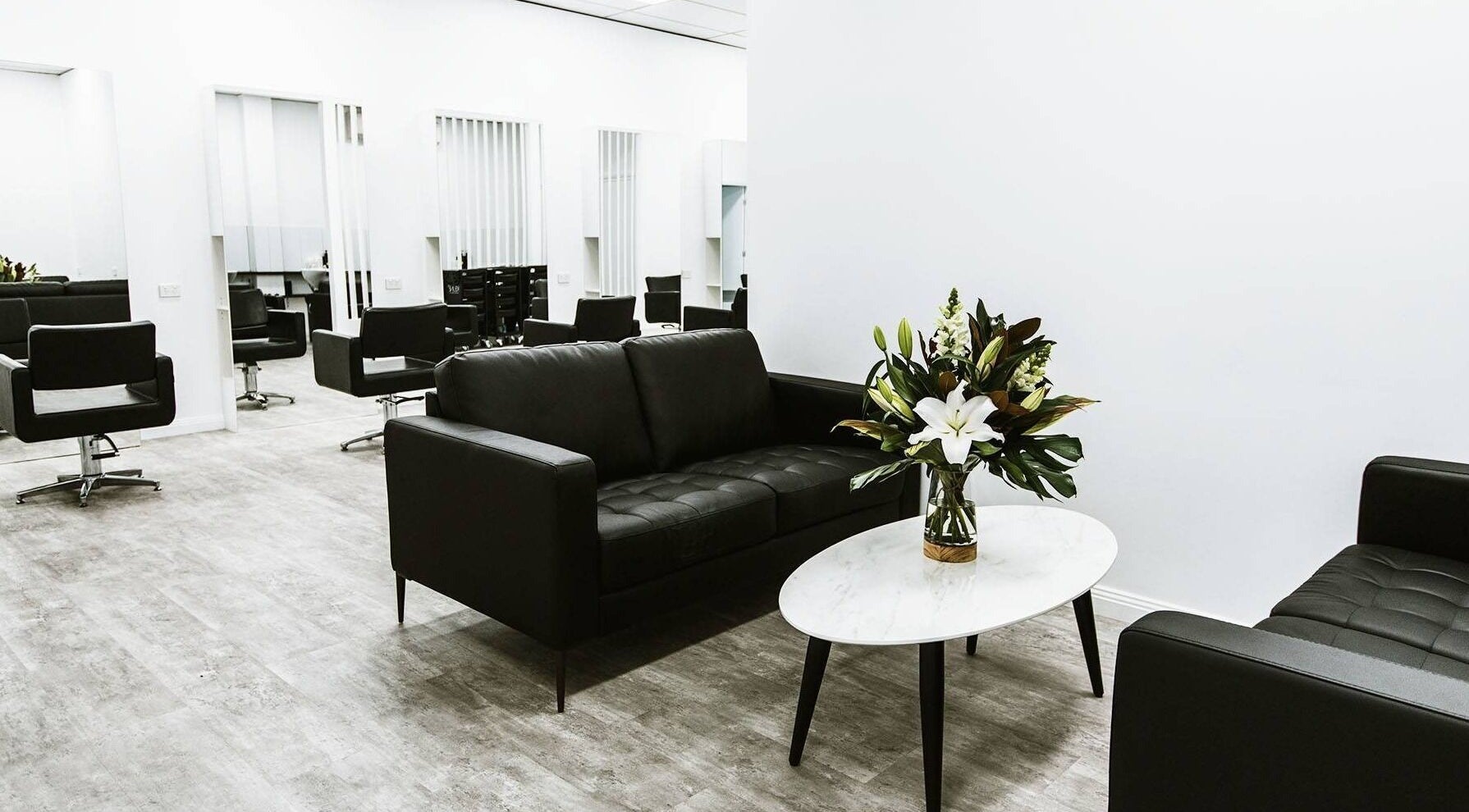 Modern salon interior at Goddess Glow Tamworth, Tamworth, New South Wales, AU featuring chic black seating.