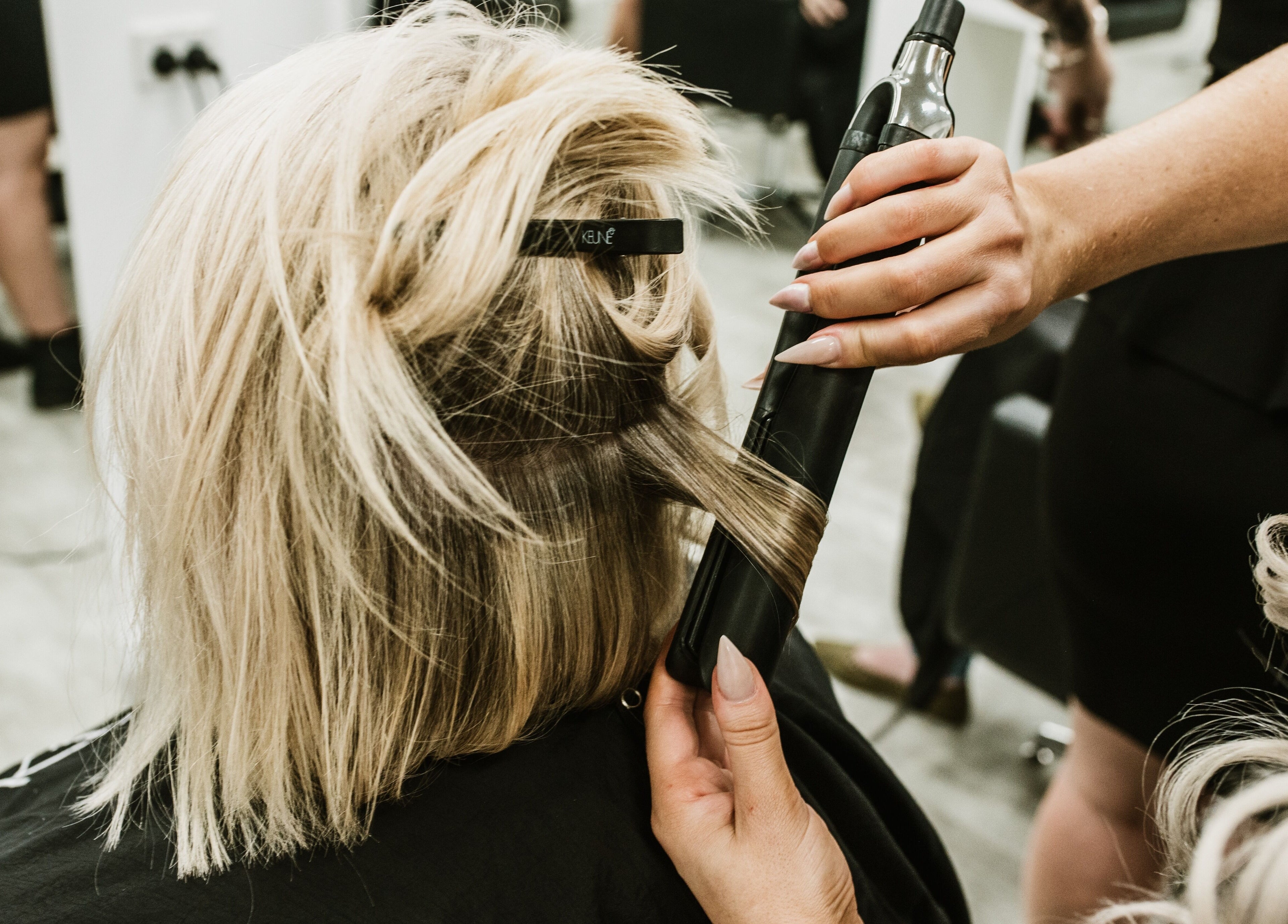 Professional hair styling at Goddess Glow Tamworth, New South Wales, AU. Achieving sleek, elegant blonde hair.