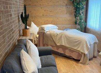 Cedar Cabin Therapies cozy room with massage bed and sofa in Holmfirth, England, GB.