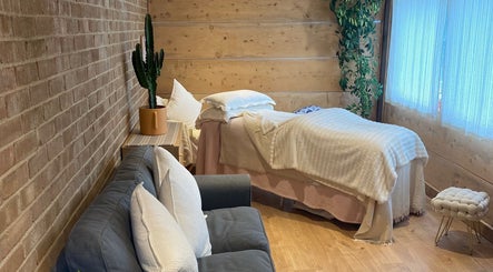 Cedar Cabin Therapies cozy room with massage bed and sofa in Holmfirth, England, GB.