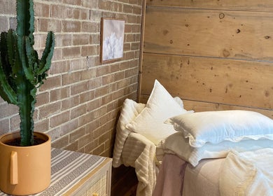 Relaxing therapy space at Cedar Cabin Therapies, Holmfirth, England, GB with cactus and soft bedding.