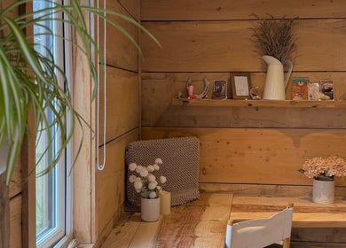 Cozy corner in Cedar Cabin Therapies, Holmfirth, England, GB with wooden decor and plants.