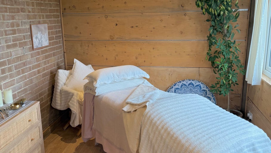 Tranquil treatment room at Cedar Cabin Therapies, Holmfirth, England, GB, featuring a cozy massage bed and calming decor.