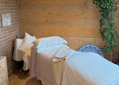 Tranquil treatment room at Cedar Cabin Therapies, Holmfirth, England, GB, featuring a cozy massage bed and calming decor.