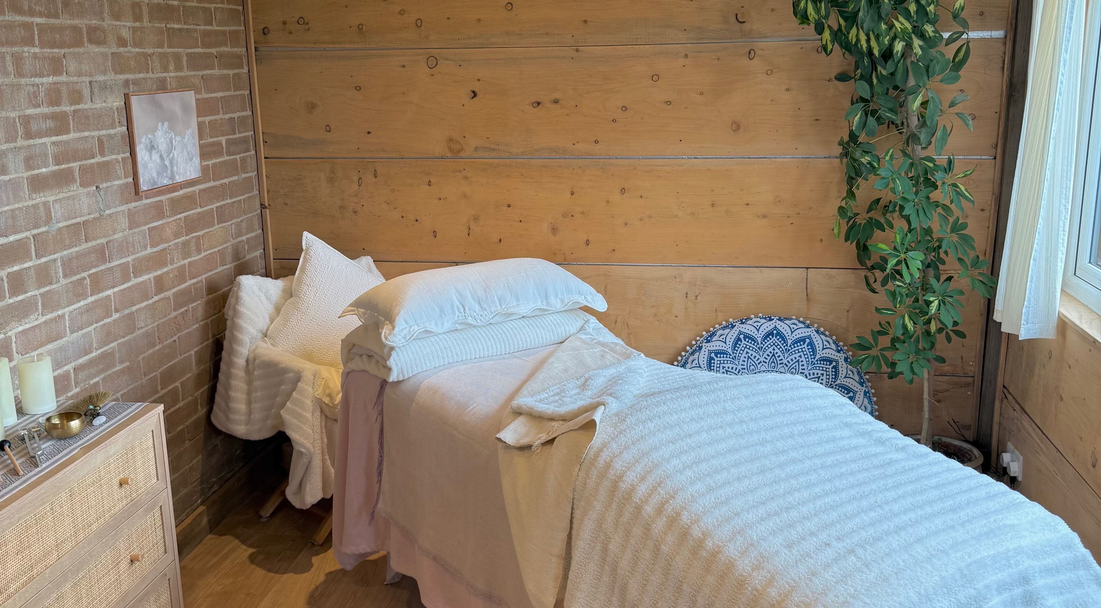 Tranquil treatment room at Cedar Cabin Therapies, Holmfirth, England, GB, featuring a cozy massage bed and calming decor.