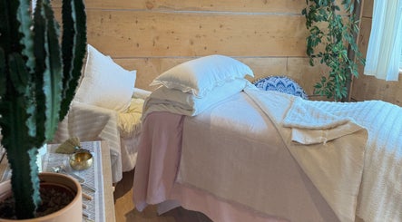 Relaxing therapy room at Cedar Cabin Therapies in Holmfirth, England, GB, featuring a comfortable massage bed.