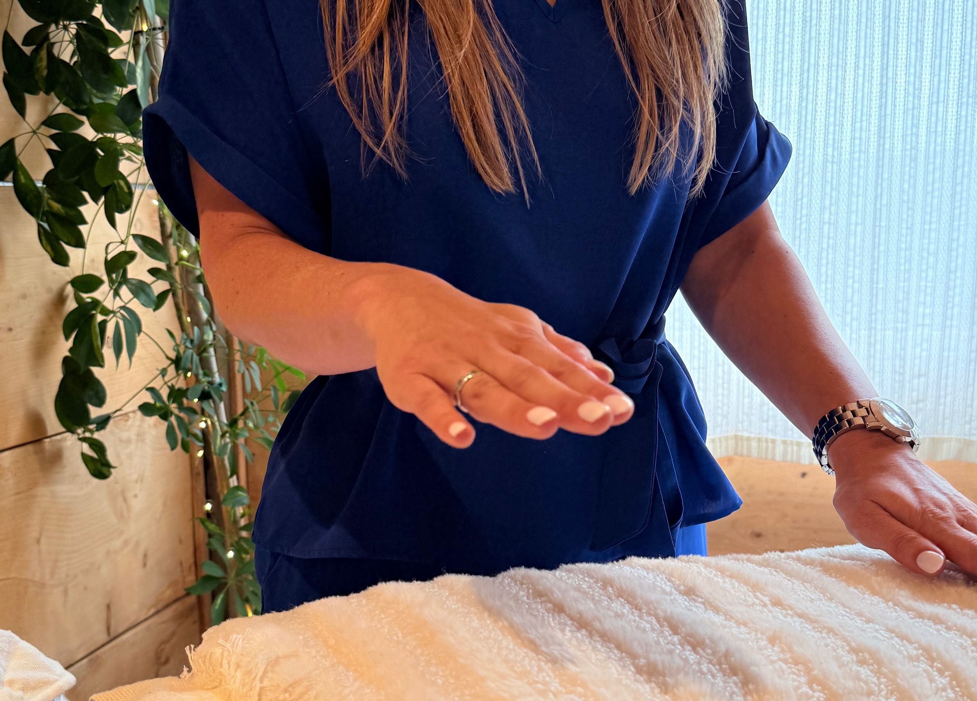 Therapist in blue uniform performing a calming therapy at Cedar Cabin Therapies, Holmfirth, England, GB.
