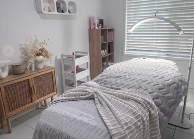 Tranquil treatment room at Glamour Goddess Lashes in Bonogin, Queensland, AU, featuring a cozy bed and soft lighting.