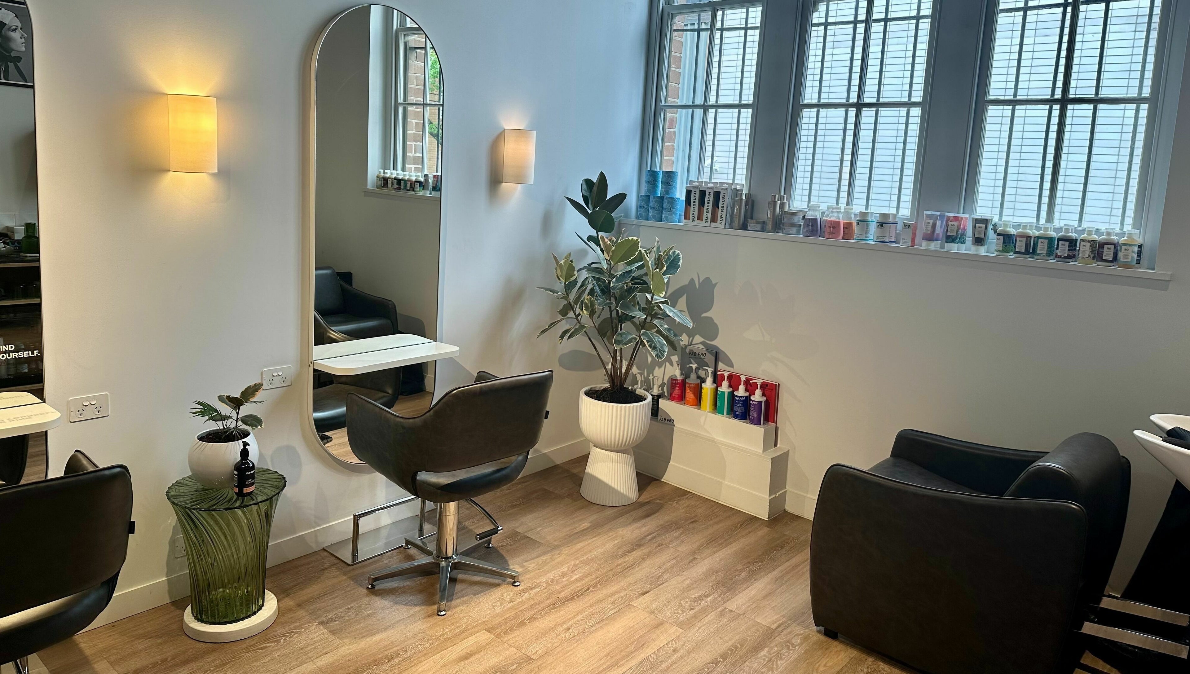 Interior of Stuart Bane Colour in Surry Hills, New South Wales, AU with modern salon chairs and mirrors.