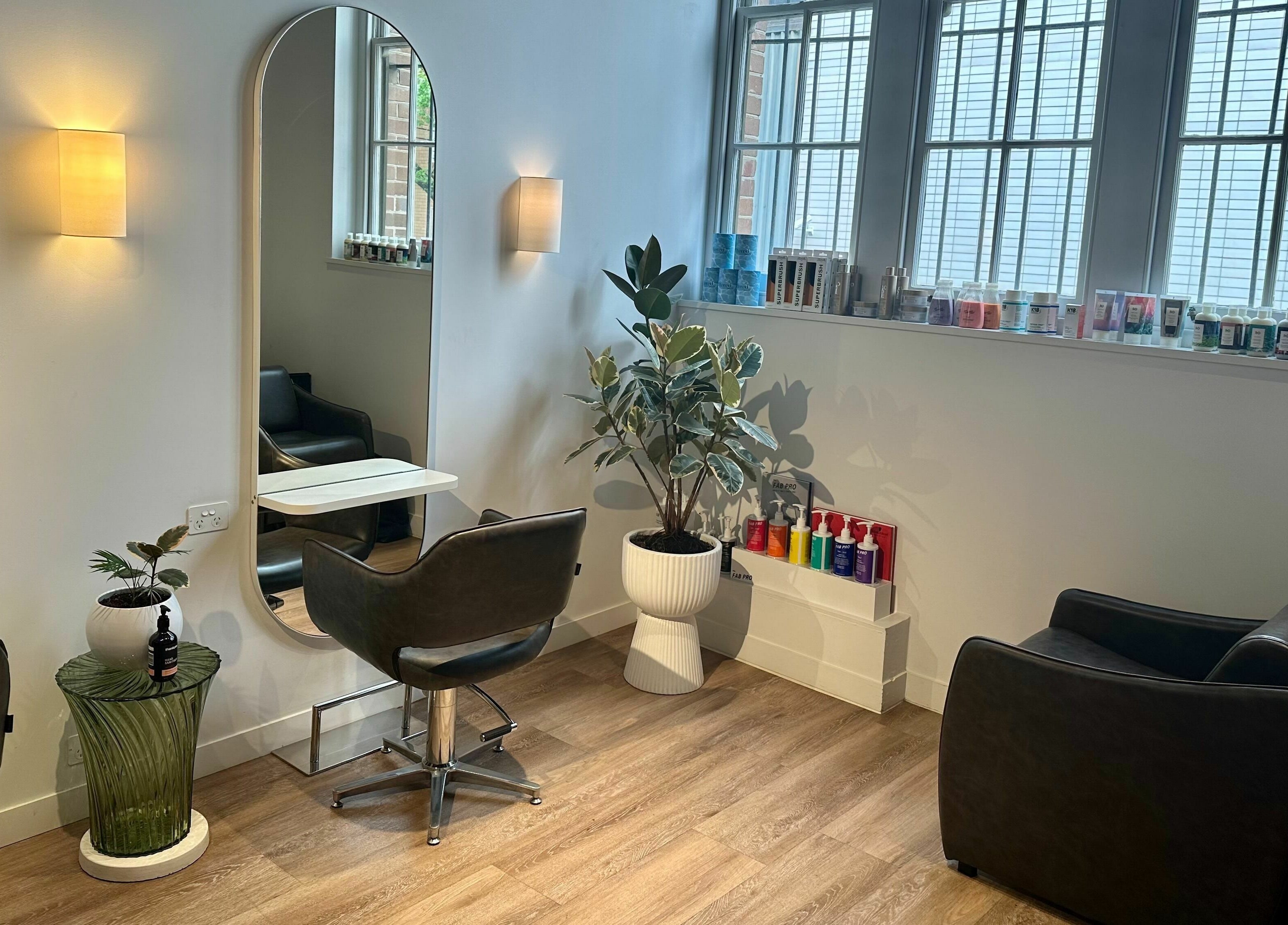 Interior of Stuart Bane Colour in Surry Hills, New South Wales, AU with modern salon chairs and mirrors.
