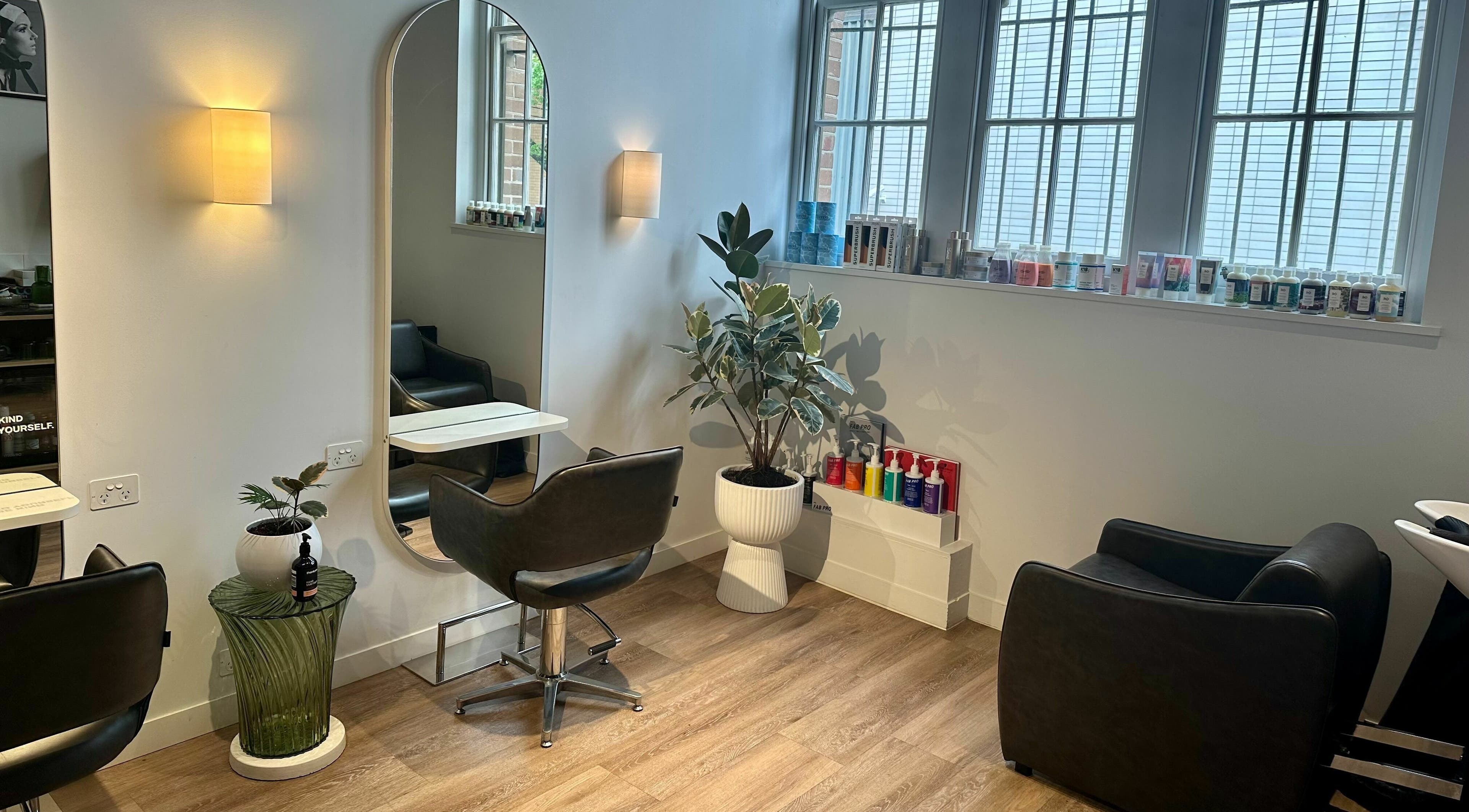 Interior of Stuart Bane Colour in Surry Hills, New South Wales, AU with modern salon chairs and mirrors.