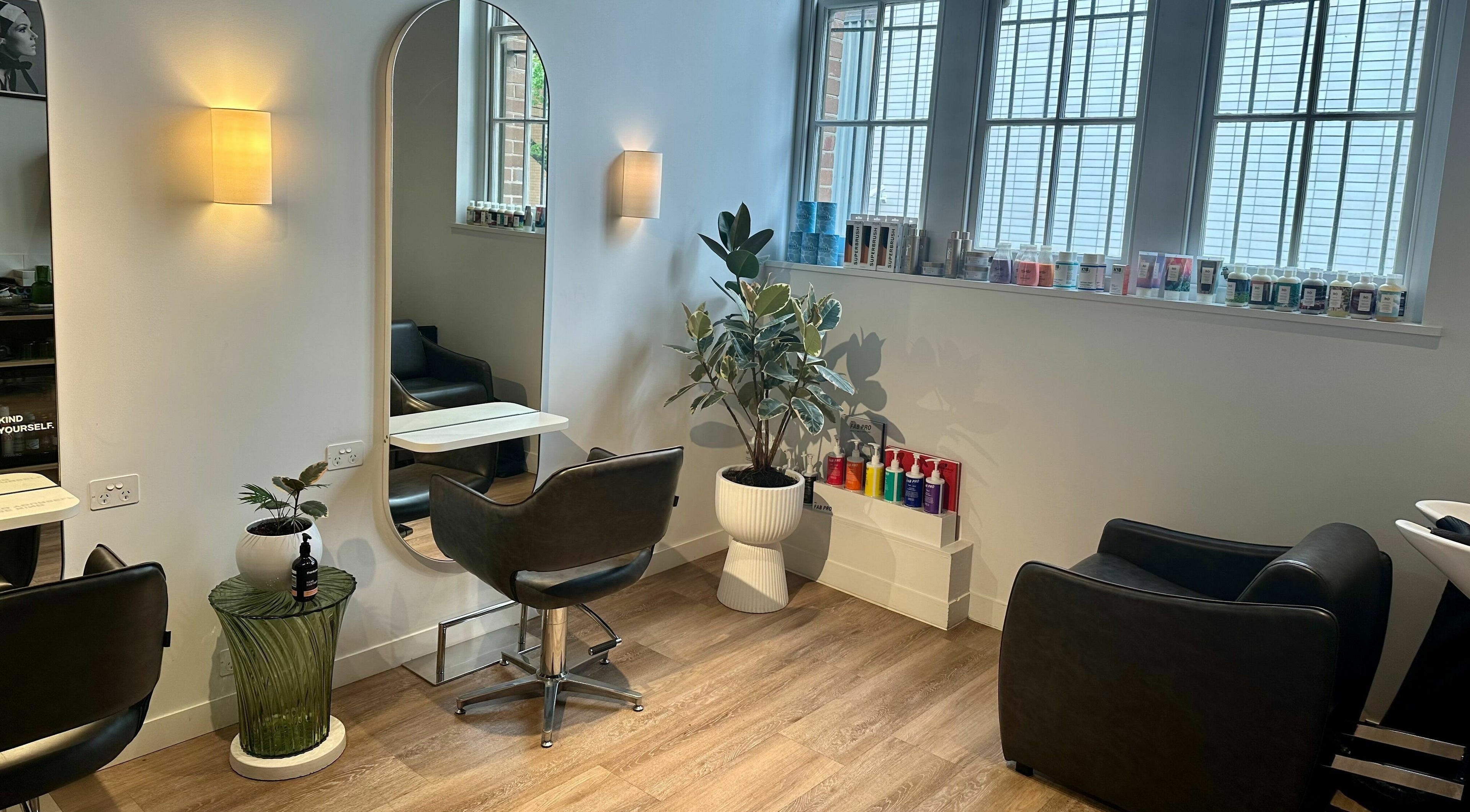 Interior of Stuart Bane Colour in Surry Hills, New South Wales, AU with modern salon chairs and mirrors.