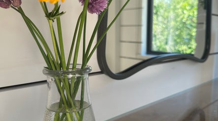 Vase with flowers at Sarah Freeman Hair-Grey Blending Specialist, Polegate, England, GB.