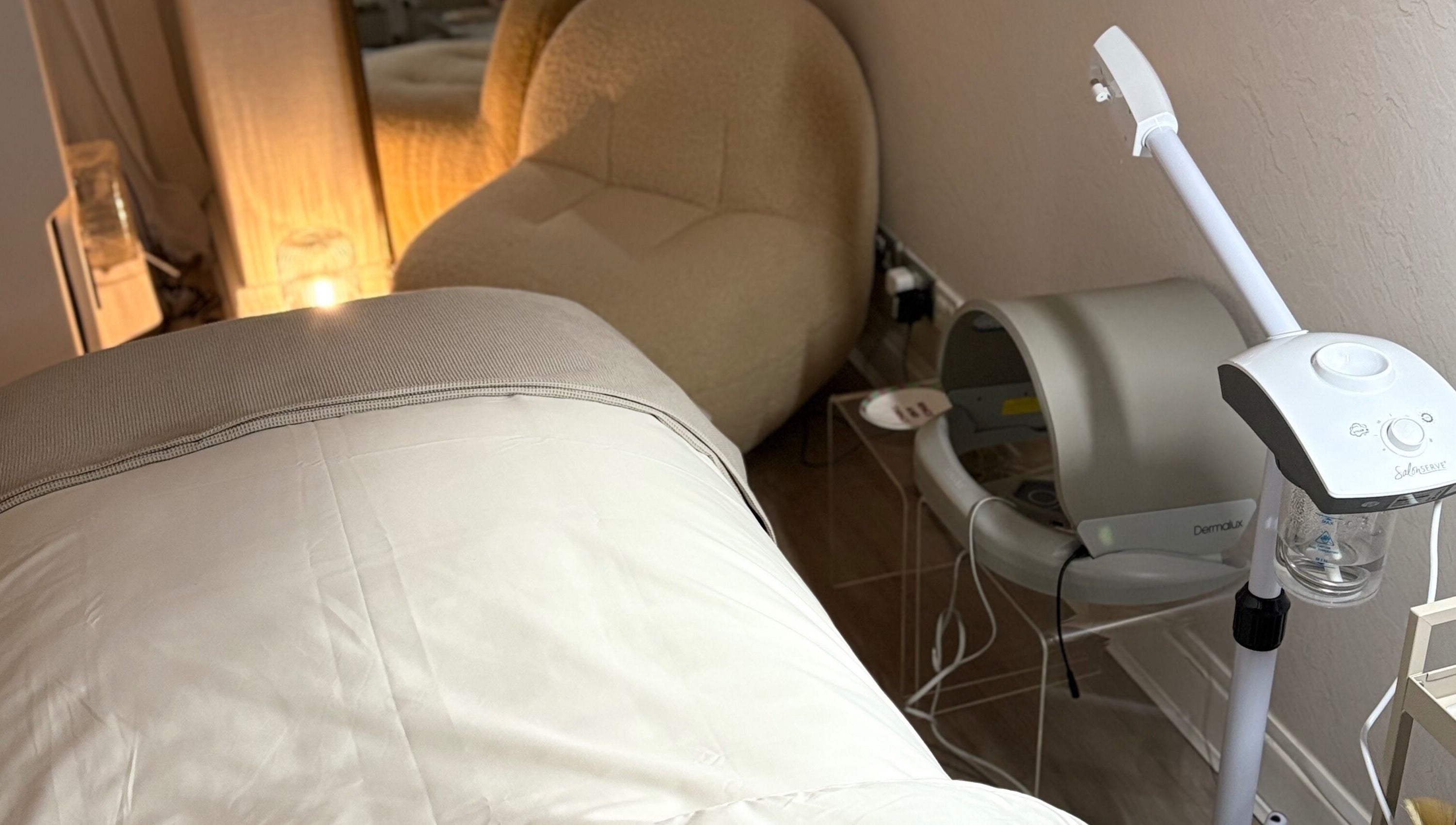 Cozy treatment room at Chloe Proud, Berkhamsted, England, GB, featuring a relaxation chair and modern equipment.
