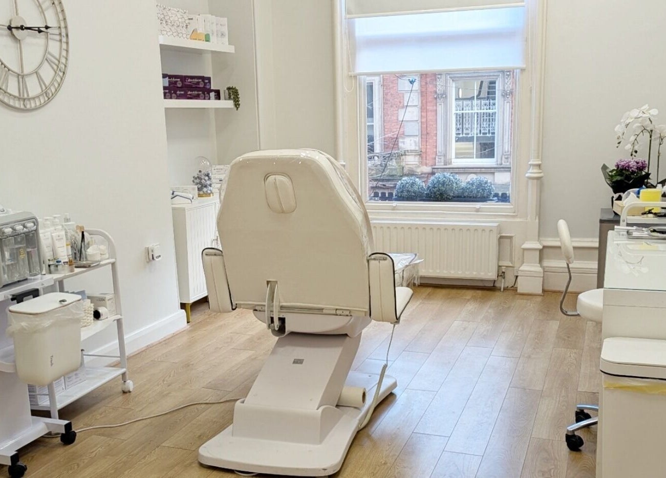 Modern treatment room at Mona Aesthetics, Leeds, England, GB, featuring a stylish chair and equipment.