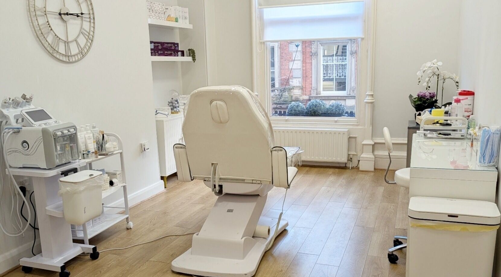 Modern treatment room at Mona Aesthetics, Leeds, England, GB, featuring a stylish chair and equipment.