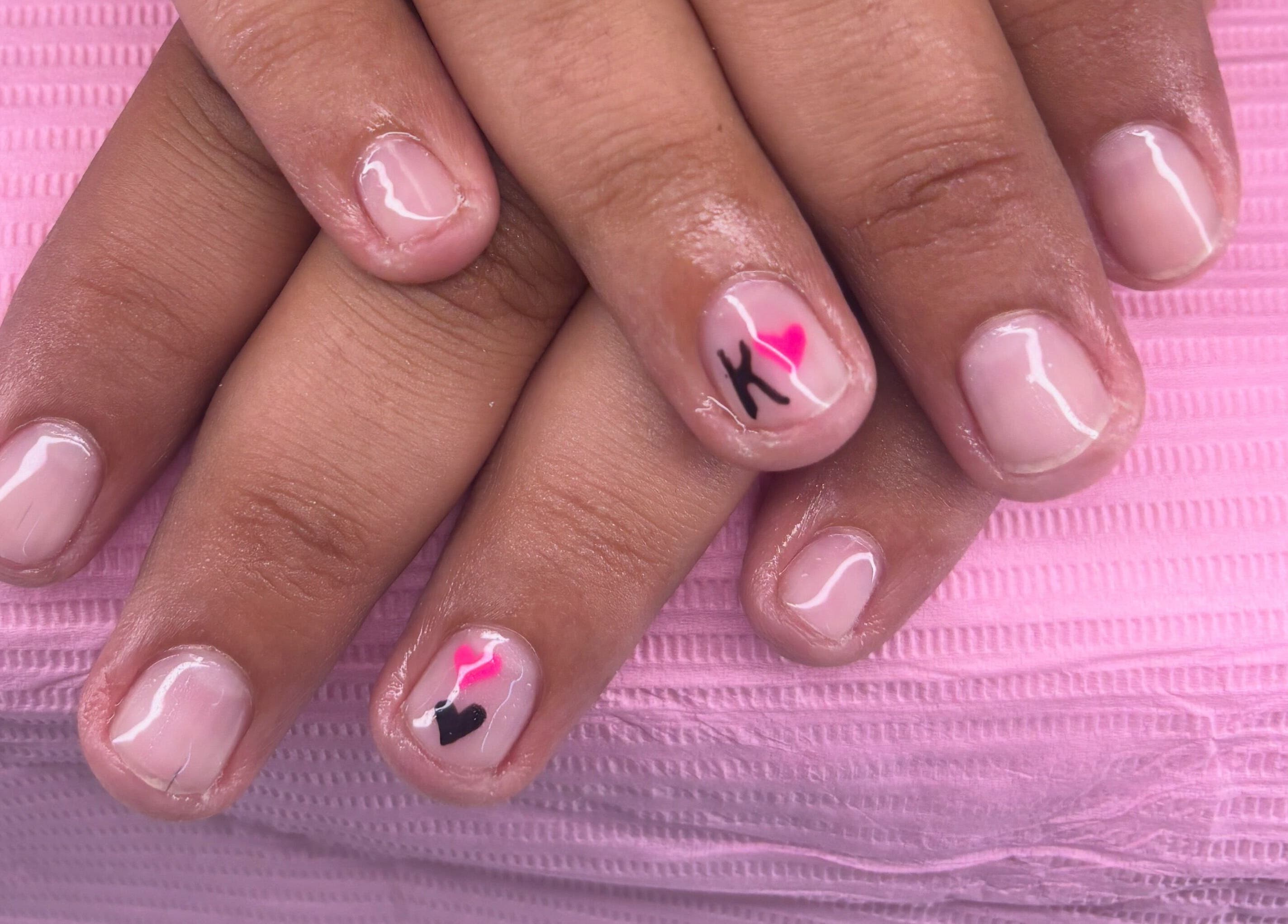 Stylish nail art at K’s NAIL BAR, Hamilton, Ontario, CA, featuring pink and black designs.
