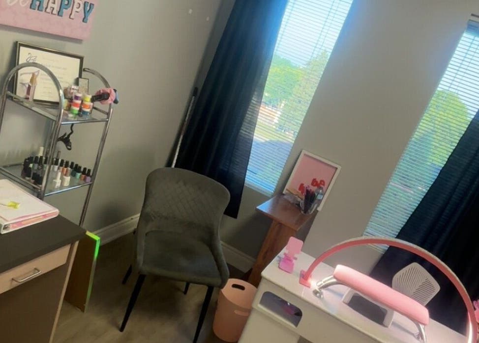 Relaxing nail station at K’s NAIL BAR, Hamilton, Ontario, CA, with polishes and certificates displayed.