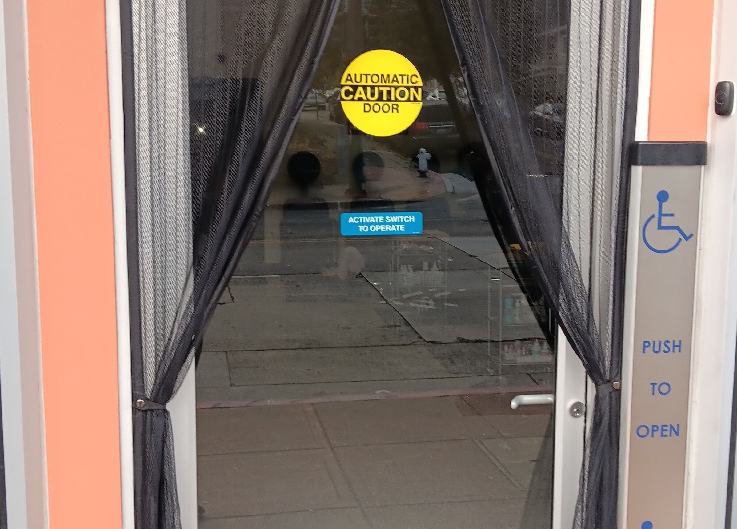 Entrance of Ke's Nail Care in Oakland, California, US with accessible automatic door feature.