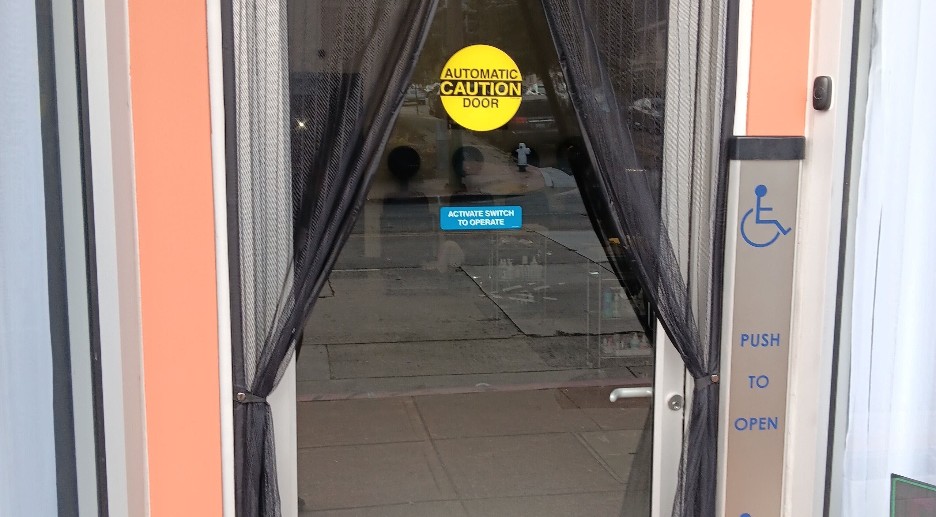 Entrance of Ke's Nail Care in Oakland, California, US with accessible automatic door feature.