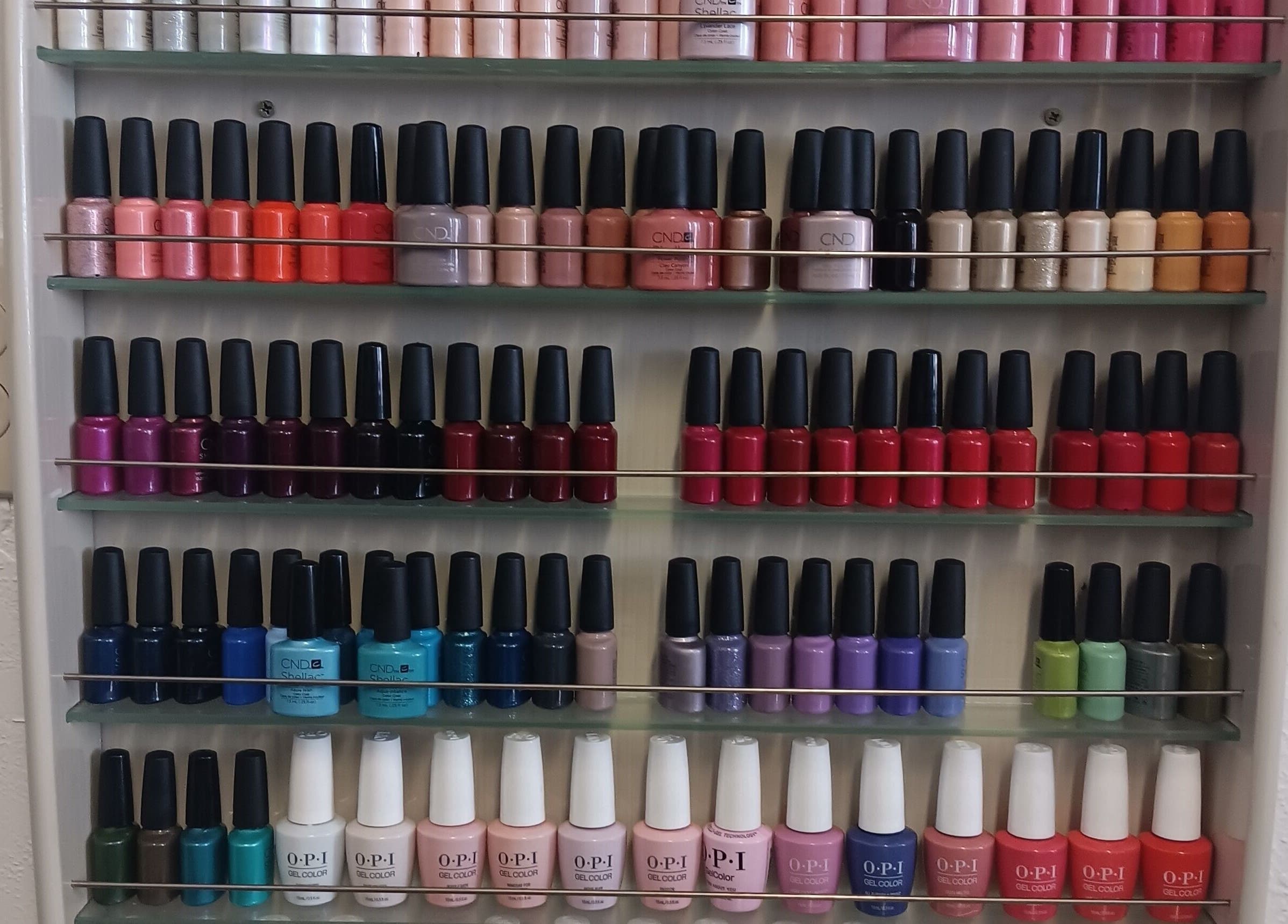 Vibrant nail polish display at Ke's Nail Care, Oakland, California, US showcasing a variety of colors.
