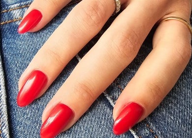 Elegant red manicure at GELuxe Nail Studio, Dapto, New South Wales, AU, showcasing vibrant nail art.